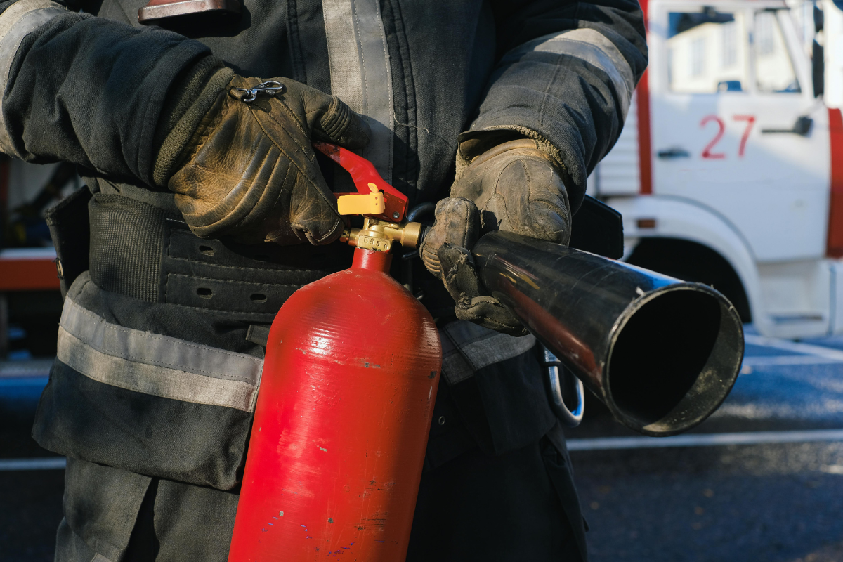 Firefighter holding a fire extinguisher.