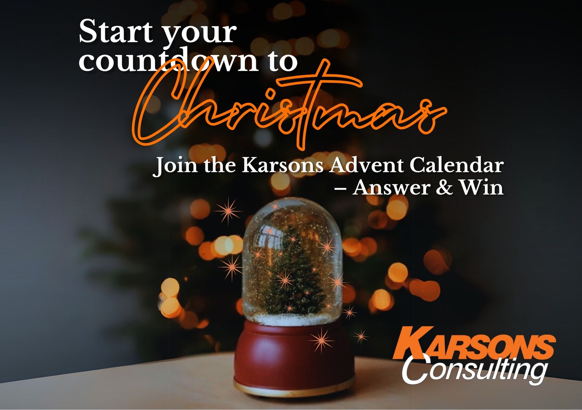 A festive snowglobe with a Christmas tree and falling snowflakes inside, set on a table. In the background, a blurred Christmas tree with warm orange and gold lights creates a cozy, holiday ambiance. The image includes text: Start your countdown to Christmas. Join the Karsons Advent Calendar. Answer & win.