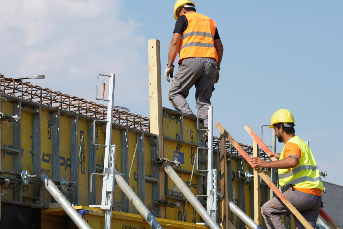 Following safety requirements during a building site visit.