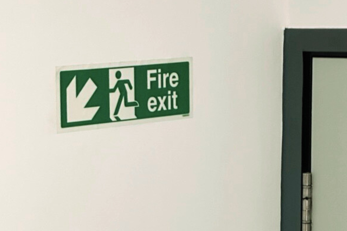 Fire exit sign in a staircase of an office building.