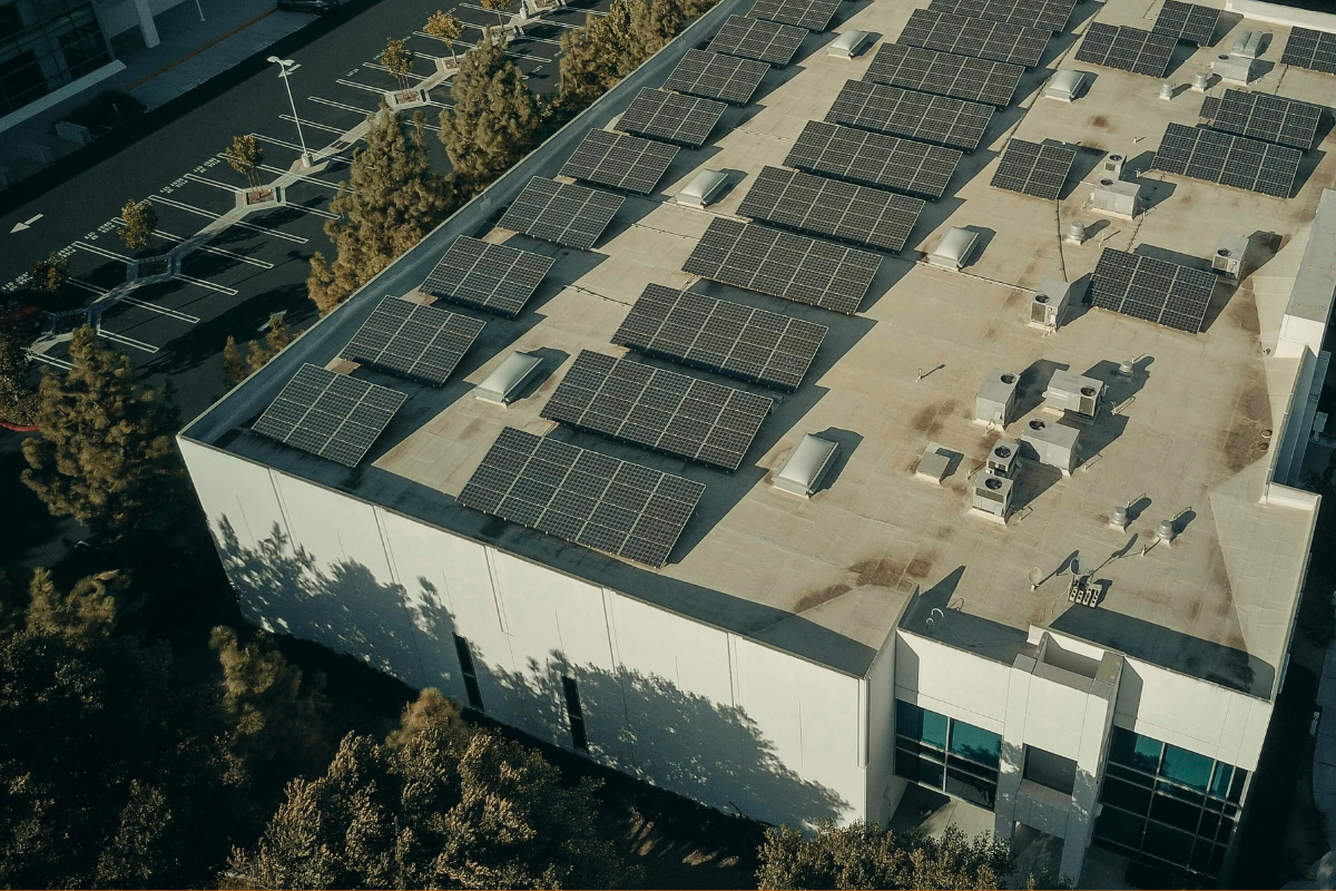 A commercial building with a solar panel installation on the roof.