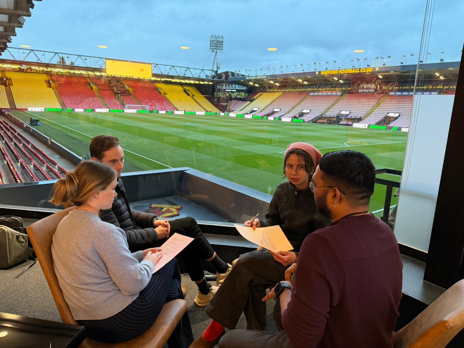 Karsons Consulting team working together during teamship challenge at Watford Stadium